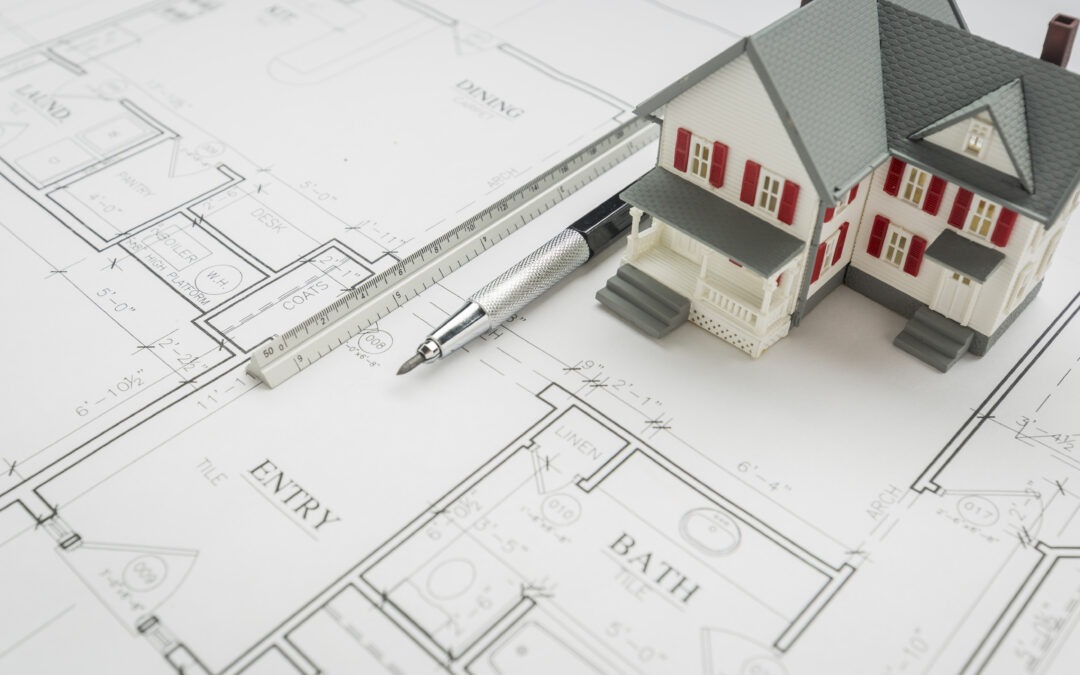 Model Home, Engineer Pencil and Ruler Resting On Custom House Plans.